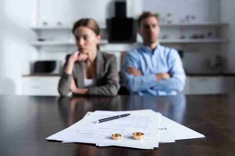 couple sitting with divorce documents