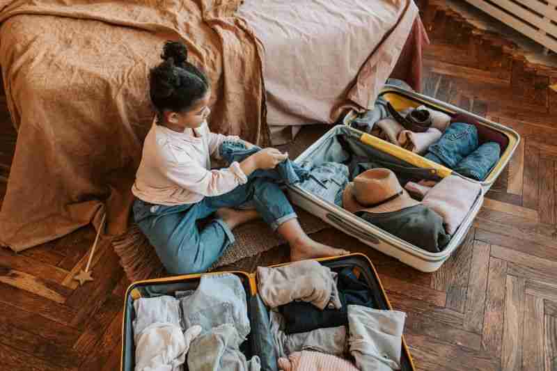child packing suitcase