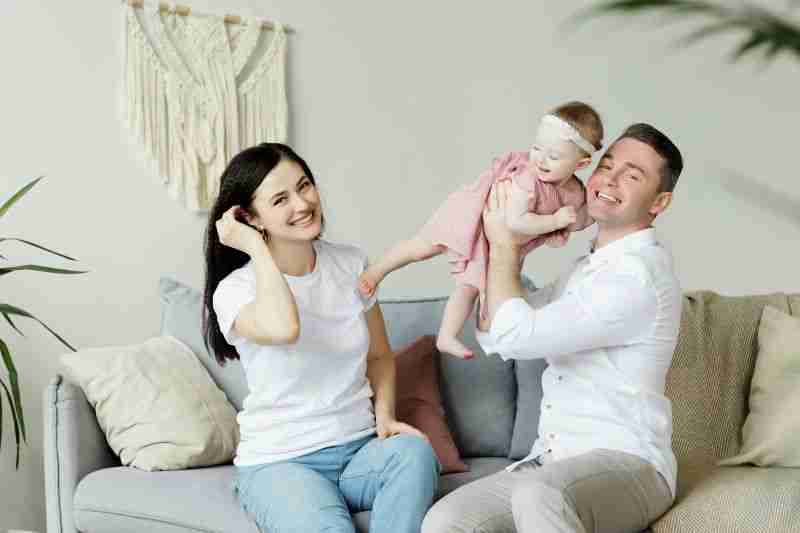 parents holding young child