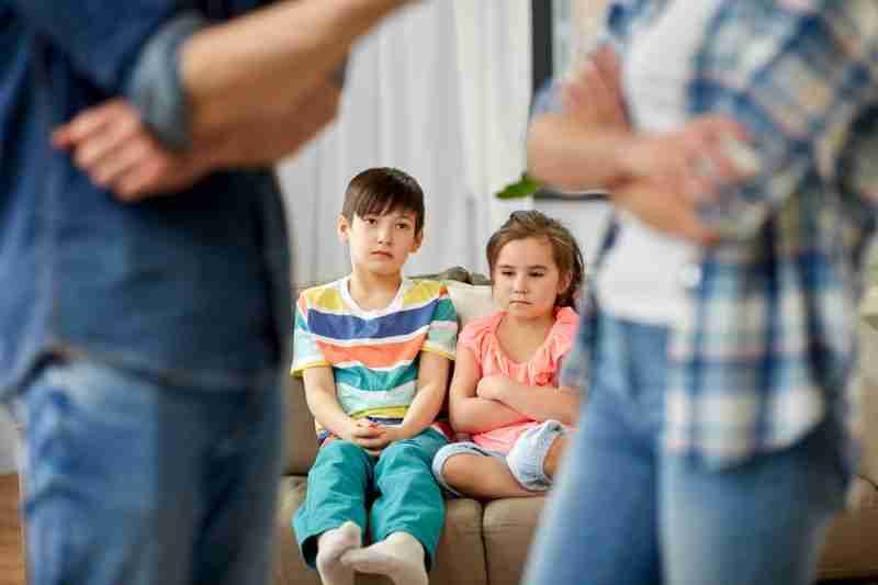 sad children with parents arguing