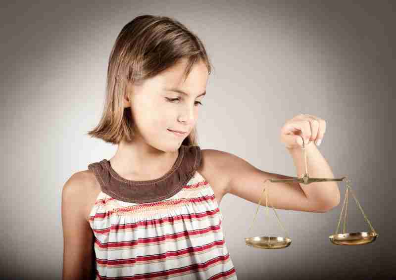 child holding justice scale