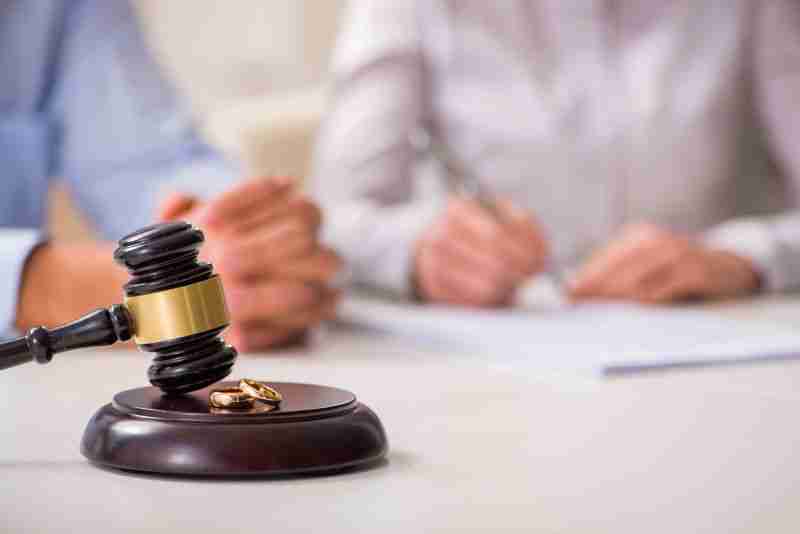 Gavel with wedding rings