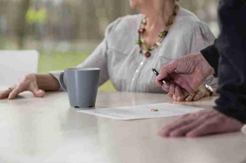 older couple signing legal papers