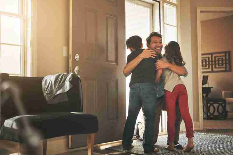 father hugging two children
