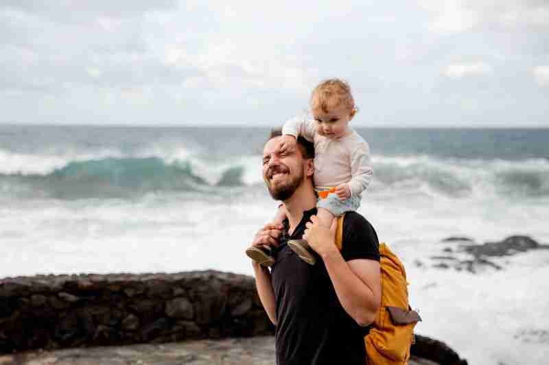 father carrying child