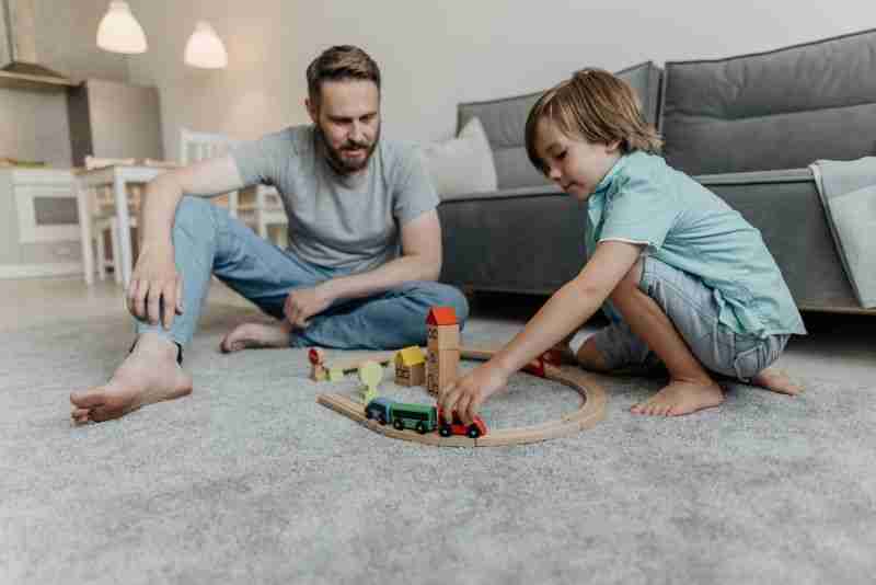 father playing trains with son
