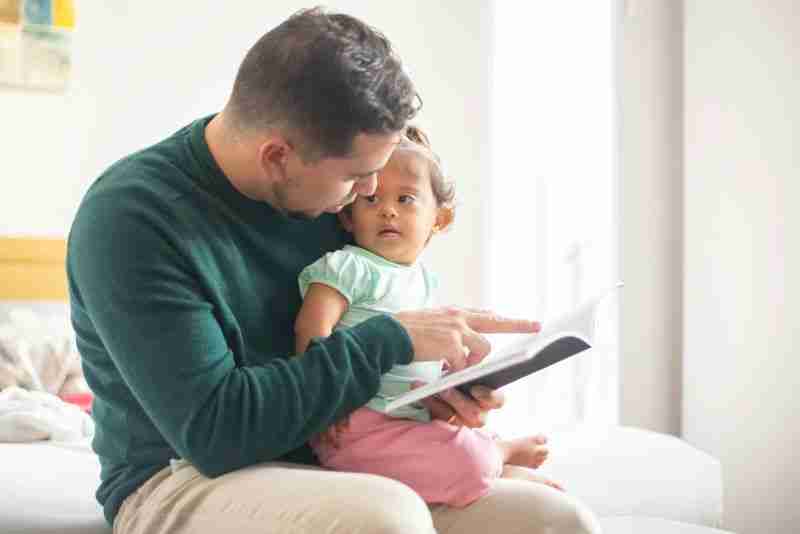 father reading to baby