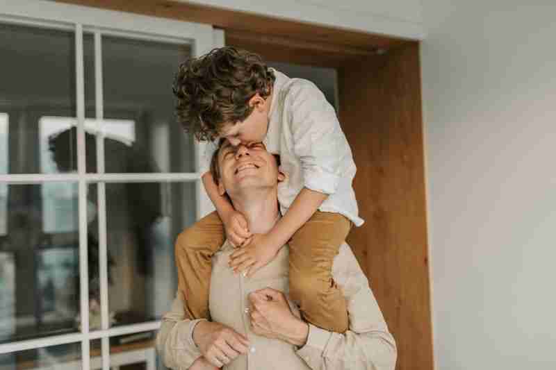 Son sitting on father's shoulders