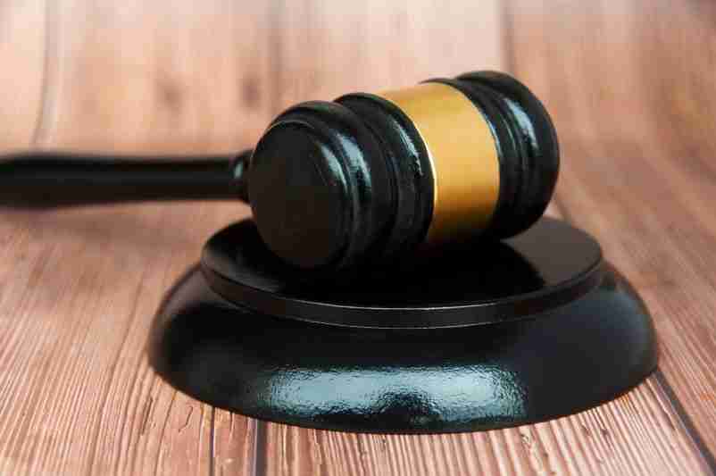 Black judicial gavel on wood