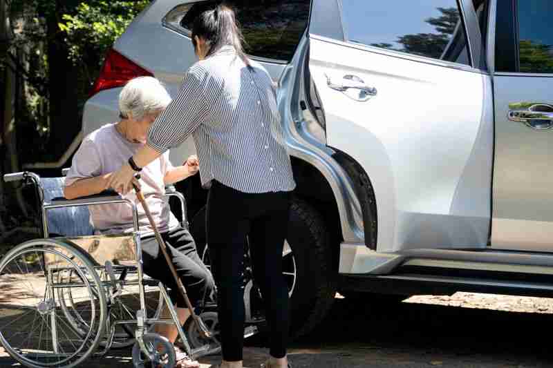 guardian helping older woman