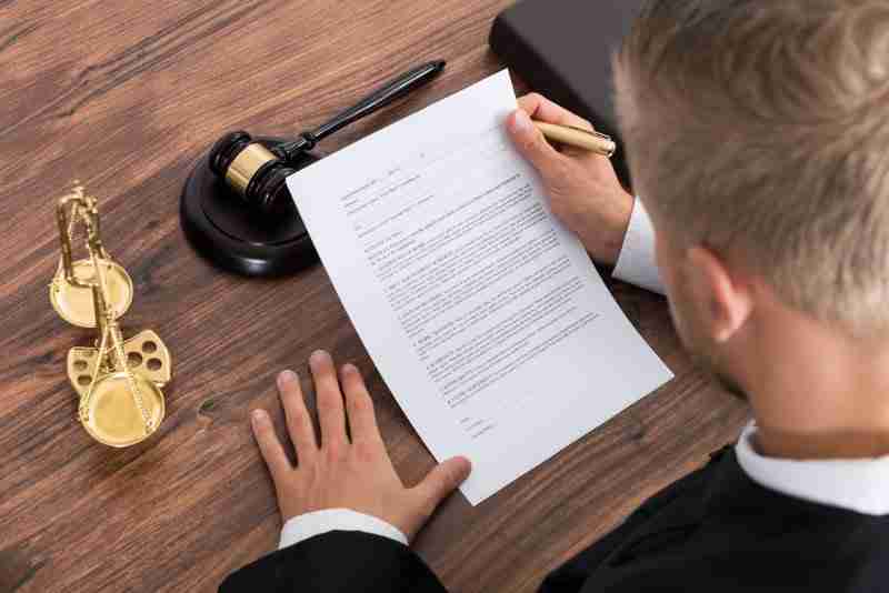 judge reading paper in court