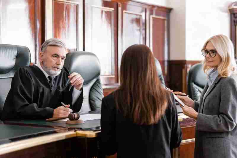 judge looking at two lawyers