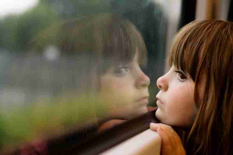 child looking out window