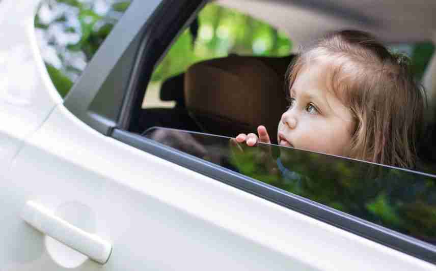 child looking over car window