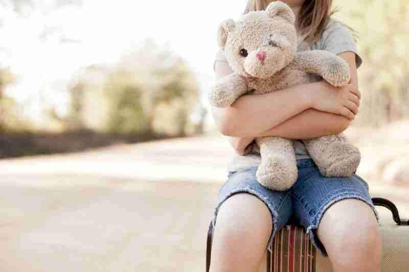 little girl holding teddy bear
