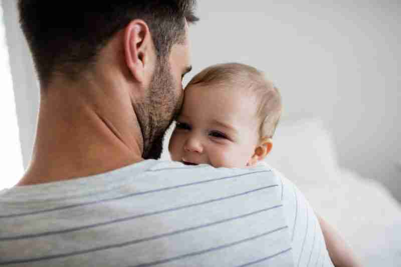 father holding child