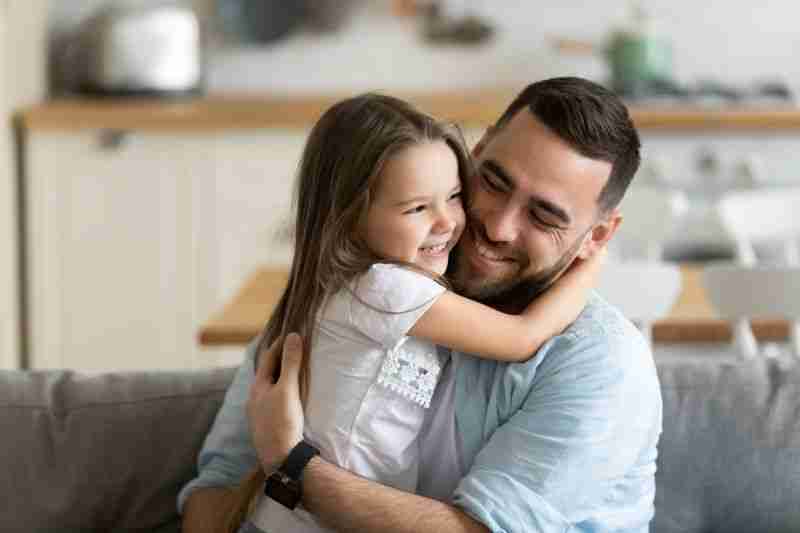 father hugging daughter