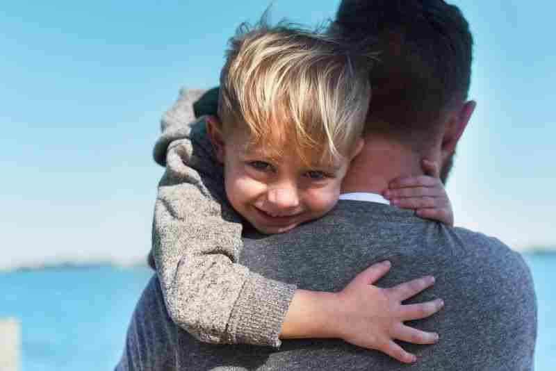 father hugging his son