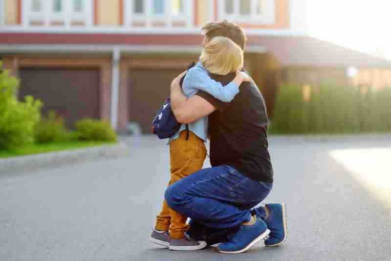 father hugging son